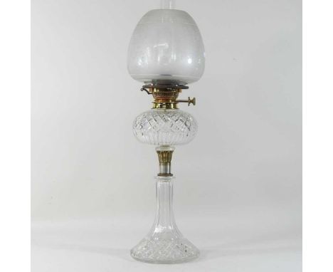 An early 20th century cut glass oil lamp, with hobnail cut decoration, brass mounts and an etched glass shade, stamped Messen