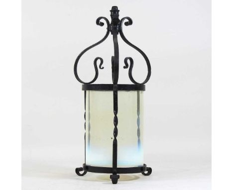 A late 19th century wrought iron hanging lantern, with a vaseline glass shade37cm high