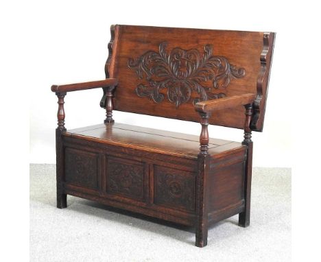 A 19th century carved oak monk's bench, with a hinged seat, decorated with scrolls22w x 58d x 114h (open)