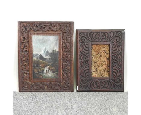 A late 19th century Black Forest carved oak panel, painted with a mountain landscape, 46 x 36cm, together with another inset 