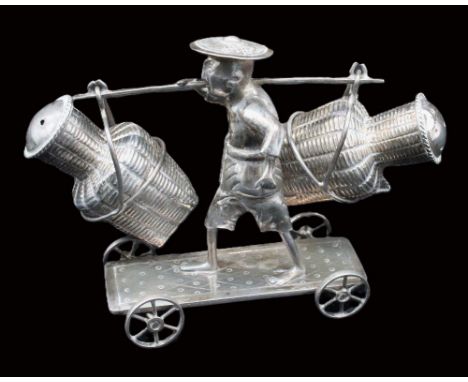 A Chinese silver figural cruet set, modelled as a man riding a four wheeled cart with large pots on pole in hand, pots wicker