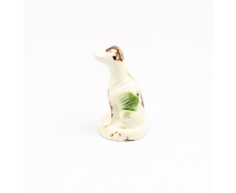 A Staffordshire creamware Whieldon style model of a seated dog, sponge decorated in shades of green and brown, c1765-70 , siz