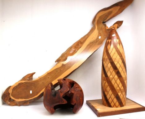 A slice of tree trunk as wall a wall hanging, shaped tree trunk knot and wooden sculpture of 'The Gherkin' (as found)