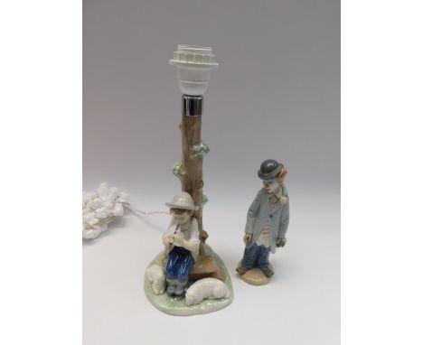 A boxed Lladro figure of a clown along with a box figure table lamp by Nao. both in good condition with no chips, cracks or r