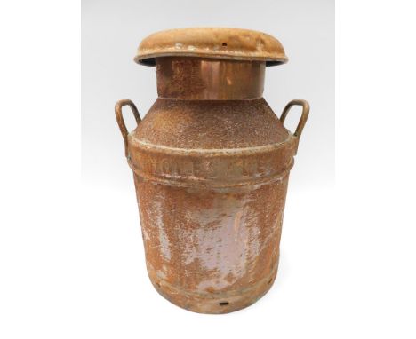 A mid 20th Century copper milk churn with lid , rusty / worn