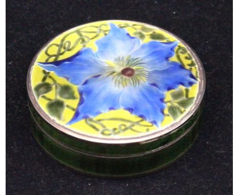 An early 20th century Continental silver and enamel trinket box, elaborately enamelled to cover with central blue flower surr