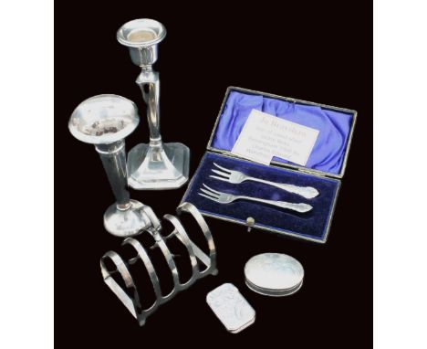 A small collection of silver to include; a George VI silver Gothic style arched toast rack, hallmarked by William Bush & Sons