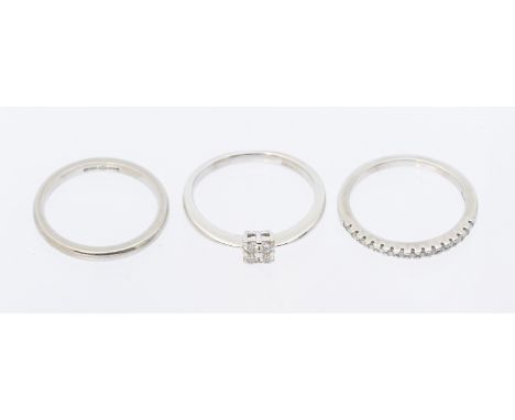 A collection of three rings, comprising an 18ct white gold engagement ring, set with four round brilliant cut diamonds in a s