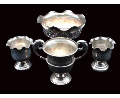 An Indian silver small trophy vase, having ornate scrolled handles with leaf detail, on circular footed base, engraved to sid