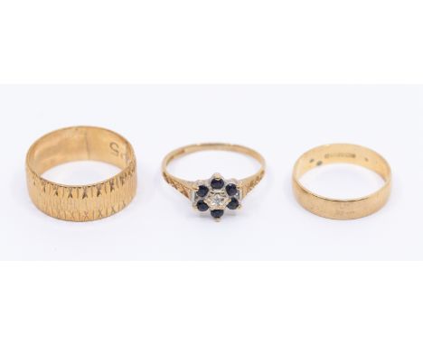 Two 9ct gold bands, widest approx 7mm, size I1/2 and L, along with a sappphire and diamond set flower cluster, size K, total 