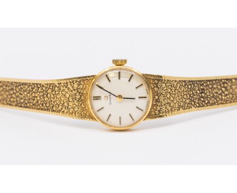 Omega- a  ladies 9ct gold vintage wristwatch, comprising a round signed silvered dial with applied baton markers, case approx
