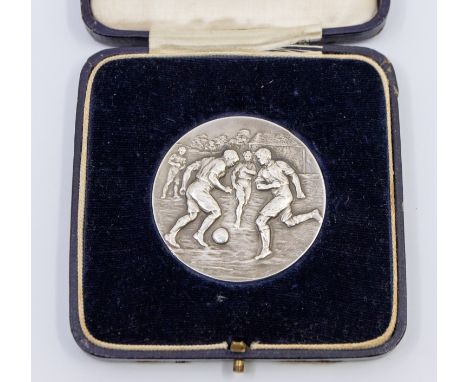 Football Medal: A silver 'Inter Platoon Football Competition' football medal embossed with a playing football scene to the fr