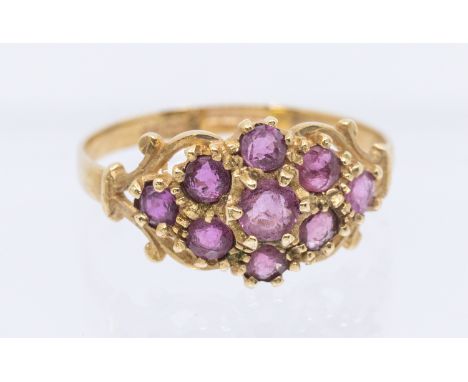 A ruby and 9ct gold cluster ring, set with round mixed cut stones, width apporox 9mm, size N1/2, total gross weight approx 2g