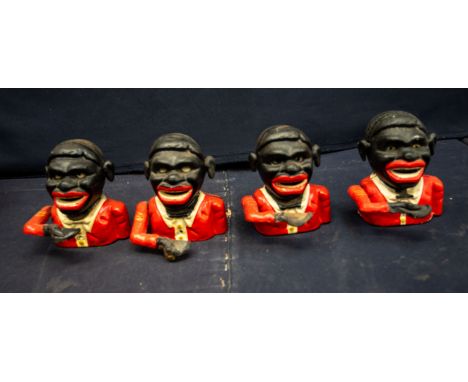 Four assorted painted cast iron money banks, each in the form of a black mans head wearing red jacket, each 13cm high Notice 