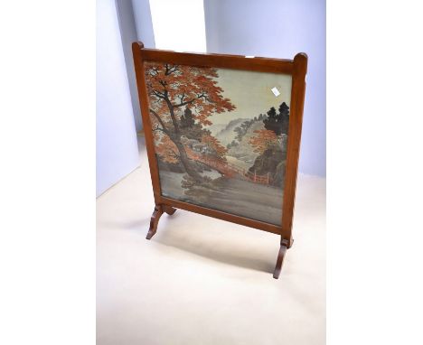 A large mid 19th Century mahogany fire screen with soldier tapestry detail with another pole screen in mahogany again wit fra
