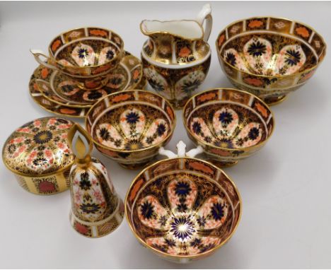 A collection of Royal Crown Derby Imari items to include: one trio, three cups, a milk jug, a sugar basin and an Imari 1128 c