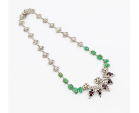 A diamond, ruby and emerald 14ct white gold necklace, the front with five leaves set with seventeen round and oval mixed cut 
