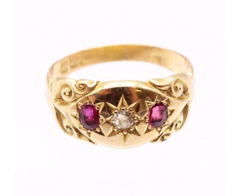 A ruby and diamond 18ct gold gold ring, comprising an old cut star set diamond to the centre, single oval mixed cut rubies se