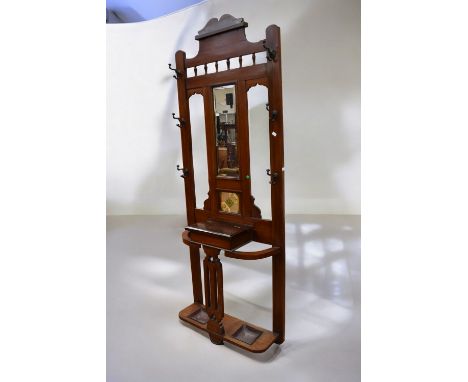 An early 20th Century arts &amp; crafts mahogany hall stand with central bevelled mirror umbrella and stick stand with glove 