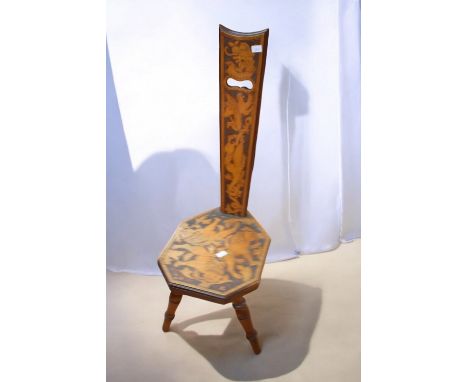 A late 19th Century Arts &amp; Crafts stick chair with ornate griffin and lion detail.