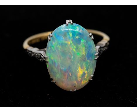 An opal and 18ct gold ring, comprising an oval opal approx 15 x 10mm, with green and orange play of colour, claw set in white