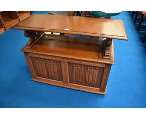 A traditional oak monks bench having linen fold decoration to panels , dimensions approx W106 D44 H75cm