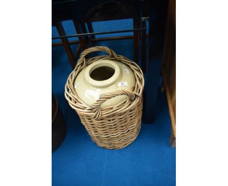 A vintage stoneware flagon , in wicker basket, stamped for Doulton and Clatyton and Jowett Liverpool