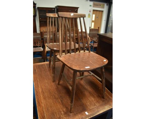 A pair of dark stained stick back kitchen chairs, similar to Ercol