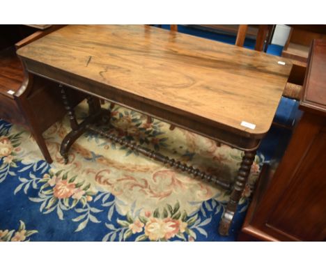 A Victorian mahogany and walnut sofa style side table having turned supports and stretcher