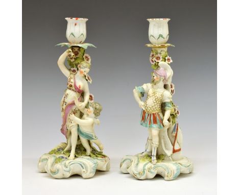 Pair of 18th Century Derby porcelain figural candlesticks, depicting Mars and Venus, each standing before a floral encrusted 