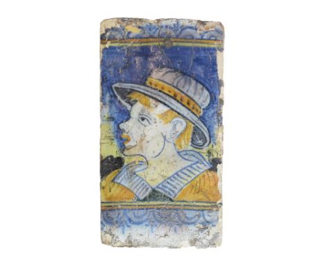 Spanish tile, probably 17th Century, polychrome decorated with the head of a young man, 29.25cm x 16cm   Condition: Being an 