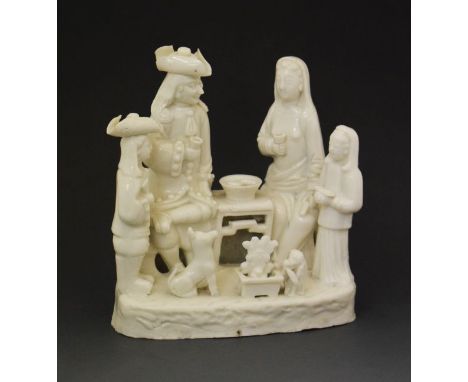 Chinese blanc de chine figure group, depicting a family of European figures seated at a table, Kang Xi period,  17cm high   C
