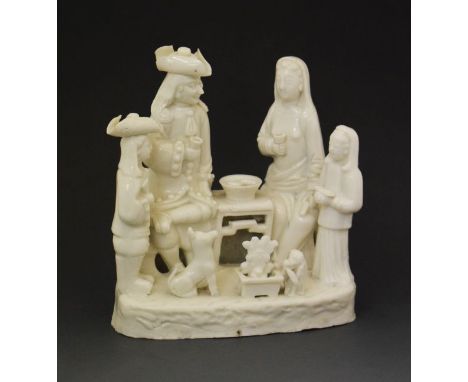 Chinese blanc de chine figure group, depicting a family of European figures seated at a table, Kang Xi period,  17cm high   C