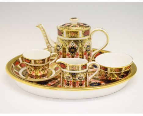 Royal Crown Derby miniature tea-for-one, comprising: teapot, cup and saucer, sugar basin, cream jug and oval tray, decorated 