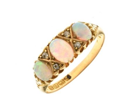 Late Victorian three stone opal ring, Birmingham 1899, the graduated cabochons with pairs of single cut diamonds between, siz