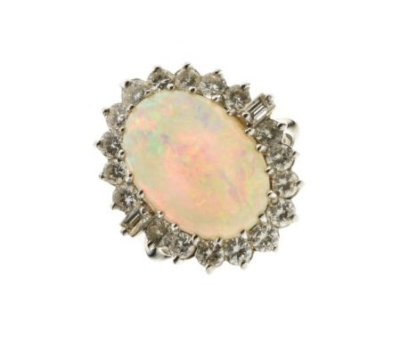 Opal and diamond 18ct white gold cluster ring, the oval shallow cabochon 16mm x 10.5mm x 4mm deep, enclosed by eighteen brill