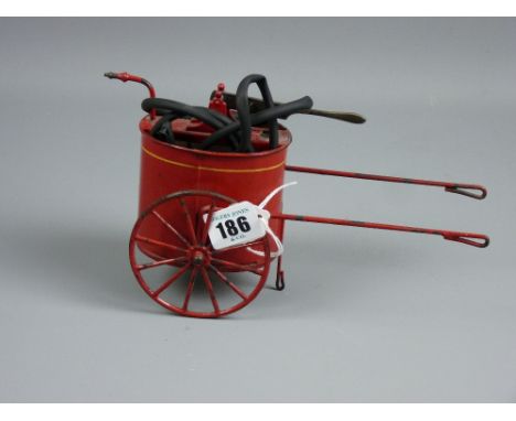 A vintage tinplate model of a firefighter's waterpump barrow with lever action pump and hose, painted in red livery, marked n