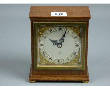 An Elliott mahogany cased mantel clock, silvered dial with Roman numerals, winged cherub gilt spandrels and winding movement 
