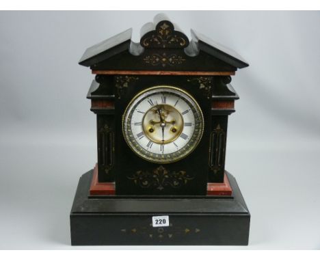 A 19th Century architectural style black slate and red marble mantel clock, the floral chased decorated case with eight day b