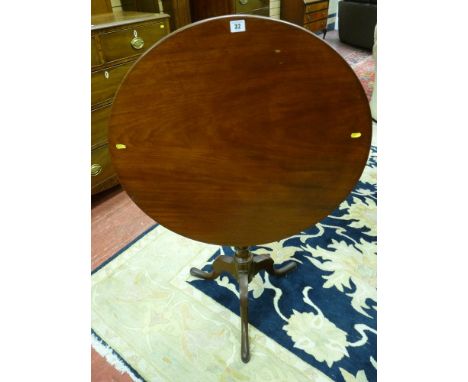 An antique mahogany circular tilt top tripod table, 74 cms high, 73 cms diameter top