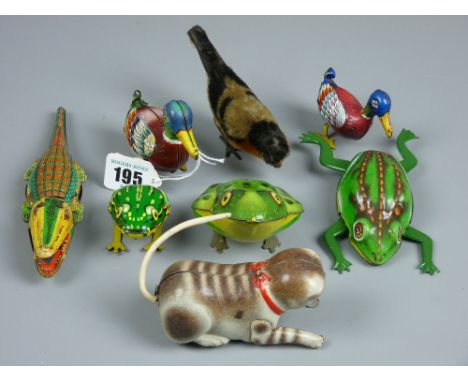 A collection of small clockwork animals to include two US Zone German ducks, two Western Germany frogs and one other, a croco