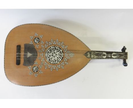 A 20th century Arabic Oud having decorative bone inlay and pierced panels to the sounding holes, labelled inside