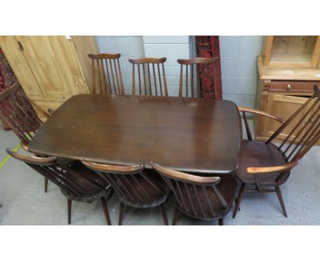 An Ercol table, along six chairs and two carvers