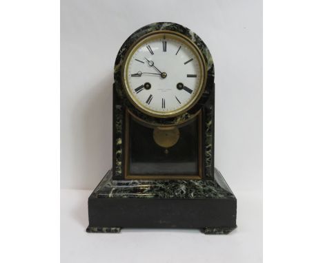 A 19th century French mantel clock having two train movement striking on a bell, circular white enamel dial indistinctly name