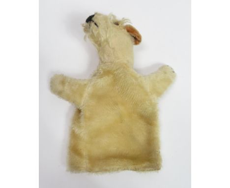 A Steiff glove puppet in the form of a terrier type dog with metal button in ear, glass eyes, stiched nose and claws and ligh