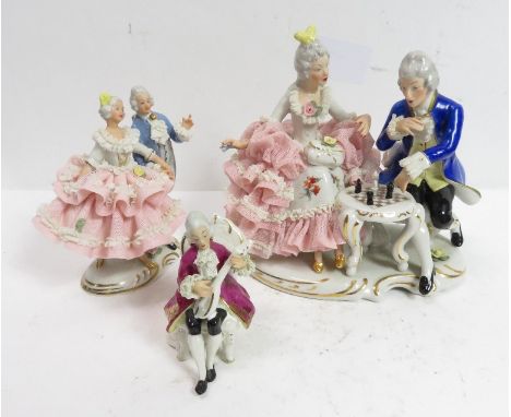 A Dresden figural group of a couple playing chess, 16.5cm high; a smaller group of a couple dancing, 12.5cm high and a figure