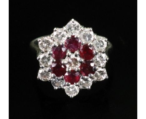 An 18ct gold, ruby and diamond dress ring of cluster design, set with alternating rows of circular-cut rubies and diamonds, o