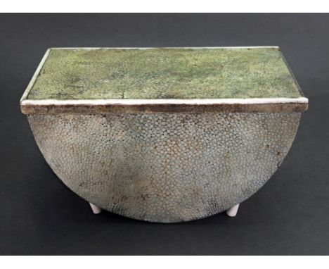 An Art Deco shagreen veneered box, the hinged rectangular ivorine banded top above the demi-lune shape box on ivorine feet, 1