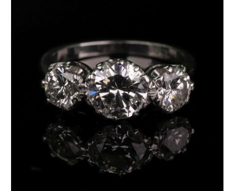 An 18ct white gold and diamond three-stone ring, total diamond weight approximately 2.10ct, ring size K, 3.9g gross. Illustra