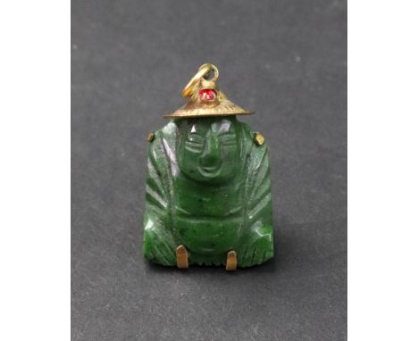 A gold mounted carved nephrite pendant, designed as a seated Buddha wearing a red paste-set hat, detailed '14 K', 7.6g gross.